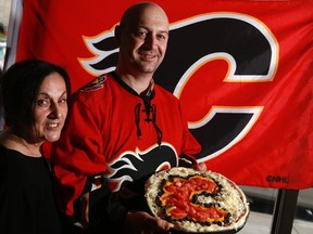 John Batas od Michael's Restaurant and Pizza show off the special Calgary Flames pizza John created for the Flames' playoff run.