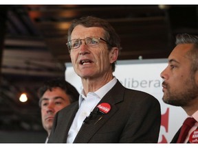 Liberal Party Leader David Swann talks to media with candidates Neil Marion, left, and David  Khan on his right, in Calgary on May 4, 2015.