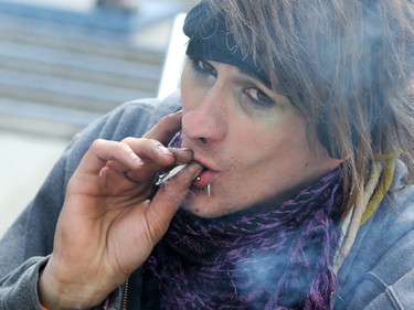 Kaeli smokes a joint at the annual Global Marijuana March at City Hall on Saturday May 2, 2015.