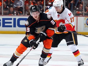 Jakob Silfverberg #33 of the Anaheim Ducks advances the puck under pressure by Johnny Gaudreau #13 of the Calgary Flames in Game One of the Western Conference Semifinals during the 2015 NHL Stanley Cup Playoffs at Honda Center on April 30, 2015 in Anaheim, California.