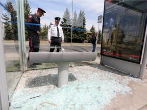 Staff Sgt. Phil Hoetger, left and Brian Whitelaw, Calgary Transit superintendent of public safety and enforcement, look at one of the 35 bus shelters in Calgary that was vandalized.