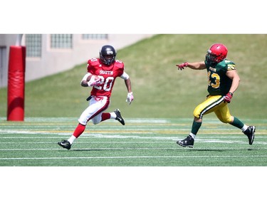 Joshua Quarles, 20, of Henry Wise Wood in Calgary looks for a path away from Cameron Saddlebrook, 43, of Jasper Place in Edmonton at the Alberta Senior Bowl all-star game between South all-stars and North all-stars at McMahon Stadium in Calgary.