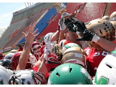 Members of the South All-Stars  hold up the trophy as they celebrate their win at the Alberta Senior Bowl all-star game between South all-stars and North all-stars at McMahon Stadium in Calgary. The South won 36 to 15.
