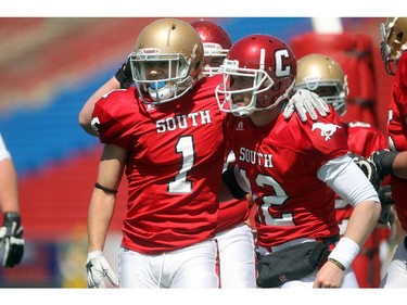 Running back Myles Brown, 1,  of Notre Dame in Calgary and Quarterback Cody Stevens, 12,  of Cochrane celebrate a touchdown at the Alberta Senior Bowl all-star game between South all-stars and North all-stars at McMahon Stadium in Calgary.