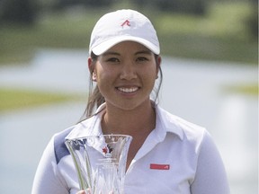 Michelle Piyapattra celebrates with her trophy after winning the Canadian Women's Tour Alberta stop at the Glencoe Golf and Country Club on Wednesday. She also received a $10,000 cheque and an exemption into the LPGA Tour's Canadian Pacific Women's Open later this summer in Coquitlam, B.C.