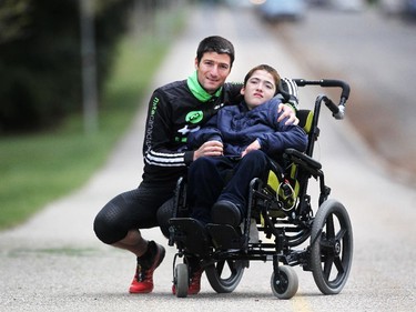 Calgary runner Blaine Penny won Wings for Life World Run Canada event in Niagara Falls on the weekend, running 65 km. He is inspired by his quadraplegic son Evan who is 11-years-old. They were photographed  on May 6, 2015.