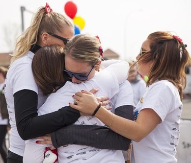 Family and friends of Jillian Lavalee comfort each other at the end of the annual Mother's Day Run that they ran in honour of her on Sunday, May 10, 2015.  Jillian loved Minnie Mouse, so friends and family ran with mouse ears and bows in their hair.