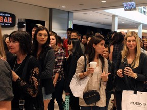 The first customers come through the doors as over 1000 customers were lined up for the grand opening of the Nordstrom store in Chinook Centre on September 19, 2014.