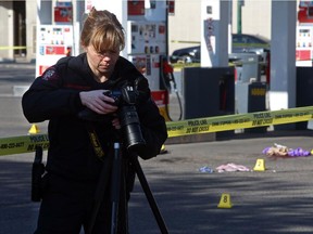 Calgary police photograph evidence at the Shell gas station in the 500 block of 17th Avenue S.W. after a woman was sent to hospital with possibly life threatening wounds following a stabbing on May 9, 2015.