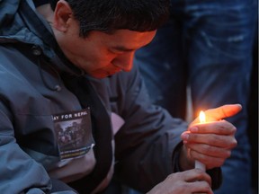 Bharat Shrestha holds a candle at the candlelight vigil held for Nepal at City Hall, in Calgary on May 1, 2015.