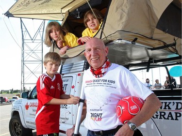 Martin Parnell surrounded by kids including Emma and Abbey Hoegg, begins his Canada Quest for Kids, where he will be attempting to set 10 World Records in 26 days across Canada in Calgary on August 25, 2014.