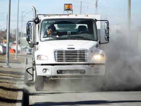 City of Calgary roads crew member Richard Withers drove his street sweeping unit along Portland Road SE on March 9, 2015.