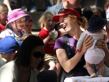Calgary's Meghan Muhle leaned over to sing with her two-year-old daughter Lily, left, while holding five-month-old Clara during a Wild Sings performance by Park's Canada Mountain WIT! at the Calgary International Children's Festival on May 21, 2015.