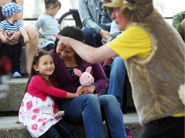 Calgary's Sophie Bullock, 4, and her mother Joyce Cortes watched as performer David Thomson sang during a Wild Sings performance by Park's Canada Mountain WIT! at the Calgary International Children's Festival on May 21, 2015.