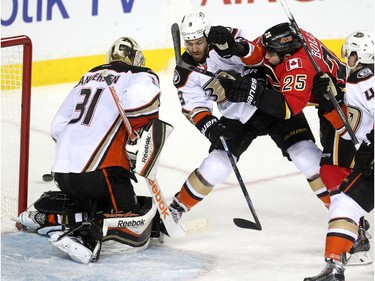 Calgary Flames left winger Brandon Bollig battled Anaheim Ducks defenceman Clayton Stoner outside the net of Frederik Andersen as a shot sailed by during second period NHL playoff action at the Scotiabank Saddledome on May 5, 2015.