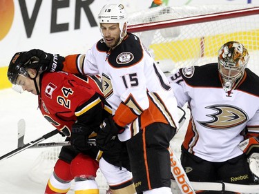 Calgary Flames centre Jiri Hudler got a little love tap from Anaheim Ducks centre Ryan Getzlaf outside the net of Frederik Andersen during second period NHL playoff action at the Scotiabank Saddledome on May 5, 2015.