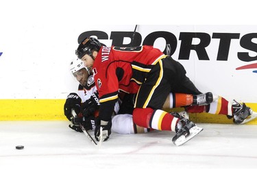 Calgary Flames defenceman Dennis Wideman and Anaheim Ducks left winger Emerson Etem got tangled up on the ice during second period NHL playoff action at the Scotiabank Saddledome on May 5, 2015.