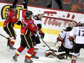 Calgary Flames centre Jiri Hudler, left, and Sean Monahan celebrate after linemate Johnny Gaudreau knocked the puck past Anaheim Ducks goalie Frederik Andersen in the dying seconds to send the game to OT. Mikael Backlund then scored the winner.