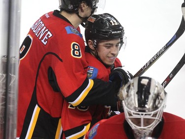 Calgary Flames centre Joe Colborne hugs Johnny Gaudreau. (Photo: Colleen De Neve)