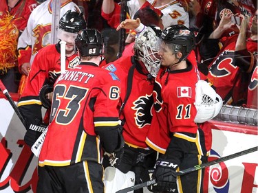 Calgary Flames goalie Karri Ramo celebrated with centre Mikael Backlund after Backlund scored the game winning goal against the Anaheim Ducks in overtime during NHL playoff action at the Scotiabank Saddledome on May 5, 2015. Backlund scored the game winning goal at 4:24  of the first overtime to give the Flames their first win in the series.