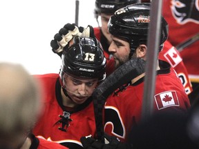 Calgary Flames left winger Brandon Bollig, right, tapped teammate Johnny Gaudreau on the head as they walked off the ice after Gaudreau scored the tying goal with 19.5 seconds left. The tally essentially saved the Flames' season.