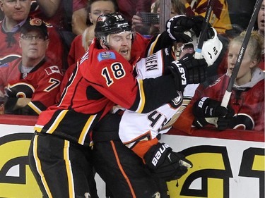 Calgary Flames centre Matt Stajan hassled Anaheim Ducks defenceman Sami Vatanen along the boards during first period NHL playoff action at the Scotiabank Saddledome on May 5, 2015.