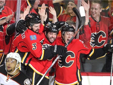Calgary Flames players, from left, defenceman David Schlemko, left winger Brandon Bollig and centre Markus Granlund celebrated after Bollig scored the Flames first goal against the Anaheim Ducks during first period NHL playoff action at the Scotiabank Saddledome on May 5, 2015.