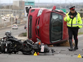 Members of the Calgary Police Service's traffic section investigate a motorcycle accident on 32nd Avenue N.W. over Crowchild Trail on May 7, 2015.