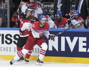 Czech Republic's Jakub Nakladal, right, challenges Canada's Sidney Crosby, left, during the Hockey World Championships semifinal last Saturday. The defensive defenceman inked a deal with the Calgary Flames on Tuesday.