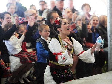 Dressed in a traditional Serbian costume, dance instructor Doris Vucijak encouraged her young dancers while they performed on the stage while parents and festival participants watched from the crowd during the Serbian Festival in De Winton on May 17, 2015.