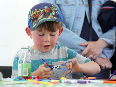 Calgary International Children's Festival visitor four-year-old Ben Remmer worked on a craft in the craft tent during the opening day of the event on May 20, 2015.