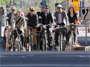 Participants in Calgary's annual Tweed Ride cycle along the 7th street cycle track in downtown Calgary on Monday, May 18, 2015.