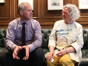 Dr. Joe Vipond, left talks with MP Linda Duncan before speaking on coal and its impact on health at the Calgary Petroleum Club.