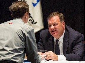Murray Edwards, chairman of Canadian Natural Resources Ltd., speaks with a shareholder after their annual general meeting in Calgary last year.