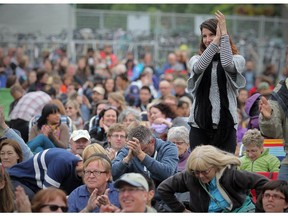 Audience members applaud an afternoon session at the National stage at the Calgary Folk Music Festival in Calgary, Alberta Friday, July 25, 2014.  The festival is facing a financial hit because of the low dollar.