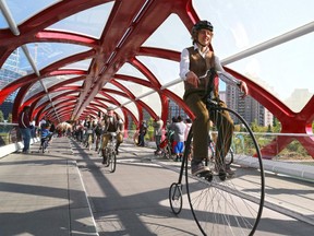 Participants in Calgary's annual Tweed Ride cycle over the Peace Bridge in downtown Calgary on Monday May 18, 2015.