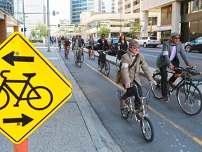 Participants in Calgary's annual Tweed Ride cycle along the 7th street cycle track in downtown Calgary on Monday May 18, 2015.