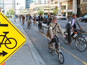 Participants in Calgary's annual Tweed Ride cycle along the 7th street cycle track in downtown Calgary on Monday May 18, 2015. Gavin Young/Calgary Herald)  (For City section story by Emma McIntosh) Trax# 00065372A