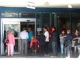 Low-income Calgarians line up for their monthly transit passes in 2012. The city has since improved the system to limit the long waits.