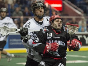 Jeremy Thompson of the Edmonton Rush, is penalized in the second quarter after a cross check on Shawn Evans of the Calgary Roughnecks in National Lacrosse League play at Rexall Place in Edmonton.