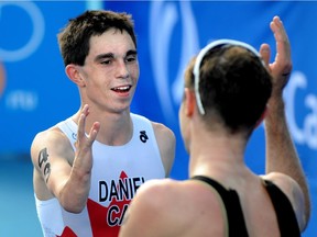 In this photo from Aug. 30, 2014 Canada's Stefan Daniel gets congrats for a second place finish from Martin Schulz from Germany who came in first in the Men's PT4 at the Elite Paratriathlon at the World Triathlon Grand Final at Hawrelak Park in Edmonton.