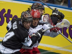 Calgary's Jeff Shattler is caught in the middle of two Edmonton Rush players during Game 1 of their National Lacrosse League West Division final at Rexall Place last weekend.