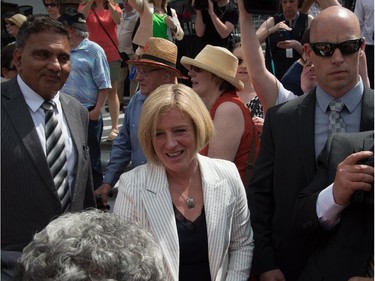 Premier Rachel Notley greets the crowd after her and 11 cabinet ministers are sworn in on the legislature steps in Edmonton.
