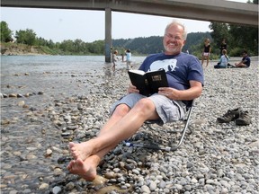 John Van Sloten, pastor at New Hope Church in Calgary, relaxes with his bible in Edworthy Park.