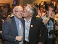 Craig Coolahan, candidate for Calgary-Klein, is celebratory kissed by Bill Hanycz as it is announced the Coolahan is leading in his riding at the Arrata Opera Centre in Calgary on Tuesday, May 5, 2015.