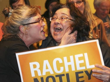 Two NDP supporters excitedly embrace after Rachel Notley is shown on a television feed at the Arrata Opera Centre in Calgary on Tuesday, May 5, 2015.