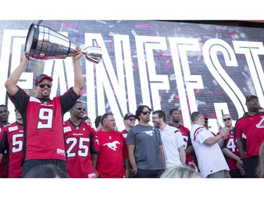 Calgary Stampeders Jon Cornish raises the Grery Cup for thousands of fans who turned out to meet the team and catch a glimpse of the Cup at the annual Stampeders Fanfest at McMahon Stadium in Calgary, on May 23, 2015.