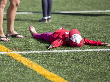 Fans get a once a year chance to actually step foot (or completely sprawl out and relax), on the Stampeders playing field during the annual Stampeders Fanfest at McMahon Stadium in Calgary, on May 23, 2015.