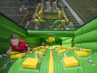 Kids have the opportunity to run obstacle course and practices their football skills during the annual Stampeders Fanfest at McMahon Stadium in Calgary, on May 23, 2015.