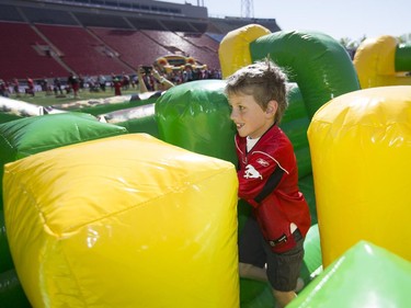 Kids have the opportunity to run obstacle course and practices their football skills during the annual Stampeders Fanfest at McMahon Stadium in Calgary, on May 23, 2015.